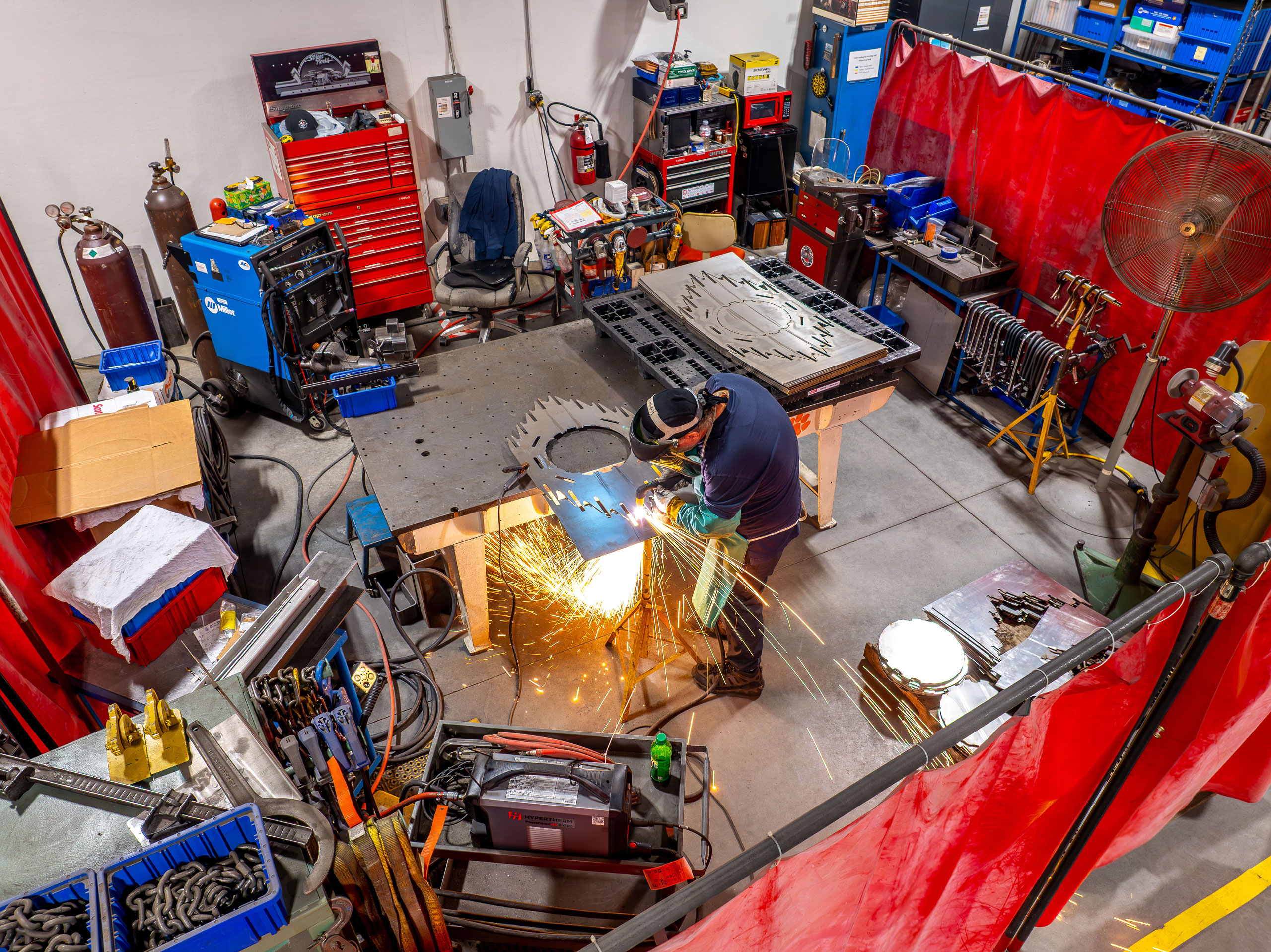 Compass team member grinding metal within the workspace