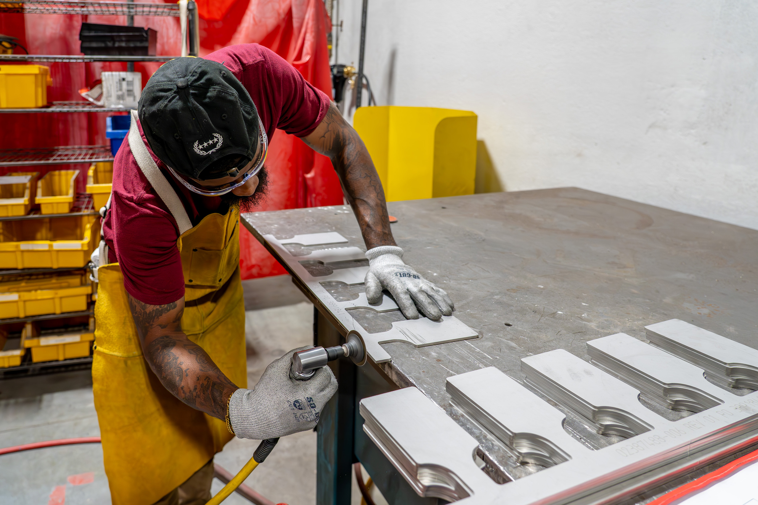 Team member lapping a piece of metal